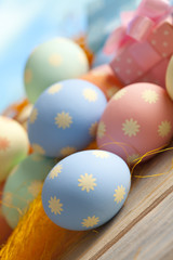 Colored Easter eggs on blue sky background