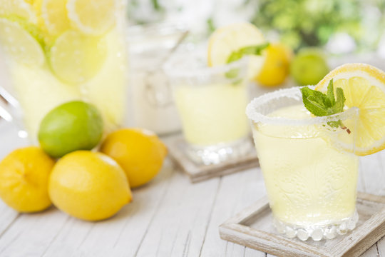 Refreshing lemonade on a rustic outdoor table in bright light