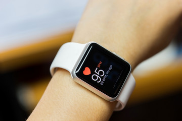 Close up white smart watch with health app icon on the screen