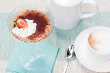 Tiramisu, traditional Italian dessert with strawberry Blue napkin