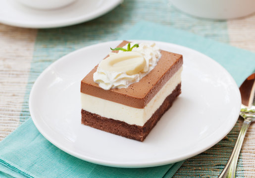 Three chocolate mousse cake on a white plate
