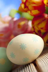Painted Easter egg and colorful flowers