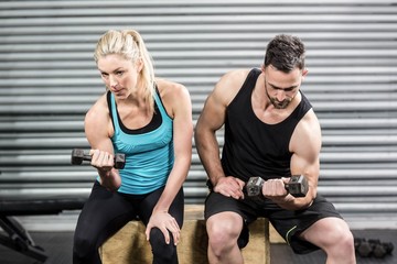 Couple lifting dumbbells together