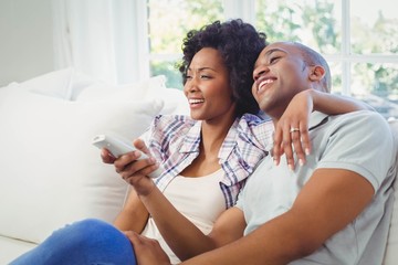 Happy couple watching tv