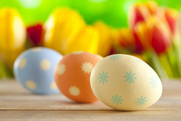 Three Easter eggs on wooden table