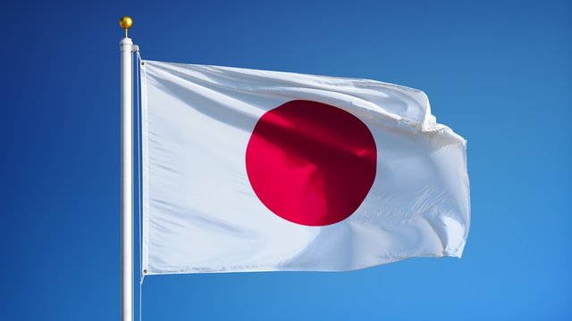 Japan flag waving in slow motion against clean blue sky, seamlessly looped, close up, isolated on alpha channel with black and white luminance matte, perfect for film, news, digital composition