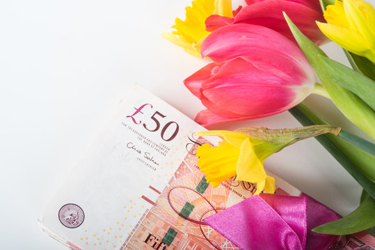 A pile of banknotes related ribbon on gift.