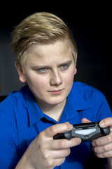 Fototapeta premium Calm teen using game controller joysticks