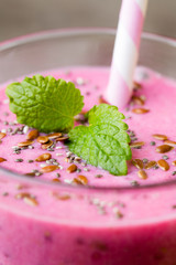 Smoothie, pink juice on the grey  background.