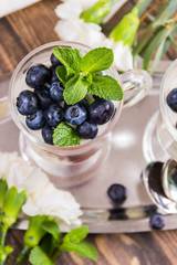 mousse of yoghurt with blueberries and raspberries, and decorated with blueberries and mint