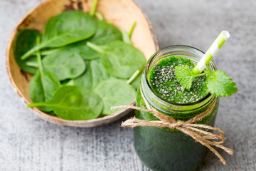 Spinach smoothie, on the grey  background.