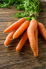 Fresh carrots on wooden table