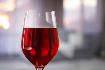 Glass of red wine on blurred background