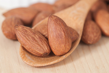 Almonds on wood spoon