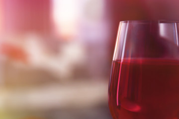Glass of red wine on blurred background