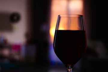 Glass of red wine on blurred background