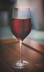 Glass of red wine on blurred background