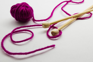 Knitting needles and balls of wool yarn