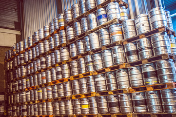 A lot of beer kegs at pallets at a brewery