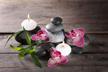 Spa still life with beautiful flower and candlelight on wooden background