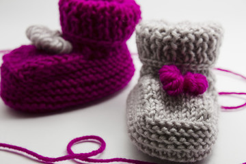 Couple knitted bootees to newborn