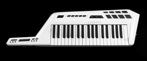 Keyboard of synthesizer on black background