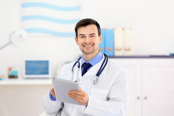 Doctor with tablet in office