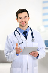 Doctor with tablet in office