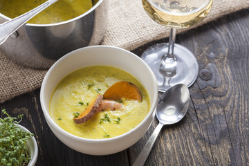 curry sweet potato soup with shrimp on vintage table