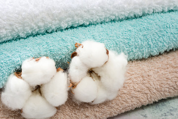 Stack of bath towels with cotton blossom