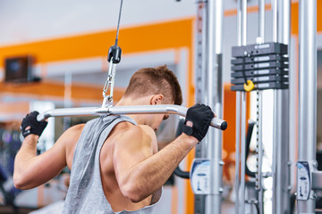 Fototapeta na wymiar muscular body building men training his back at the gym