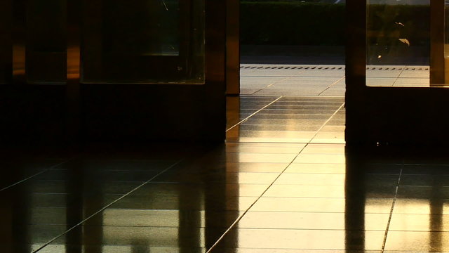 Image of an automatic sliding door reflecting golden sunset.