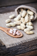 Peanut in sacks on the wooden background