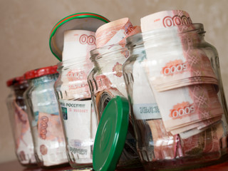 Jars of cash. Glass jars with banknotes