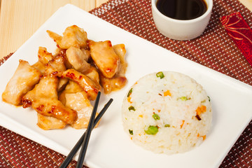 Chinese food: pork in sweet and sour sauce and rice with vegetables