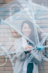 Half length of young beautiful asiatic woman standing behind and