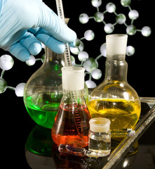 Image of different glassware and male hand in a glove closeup