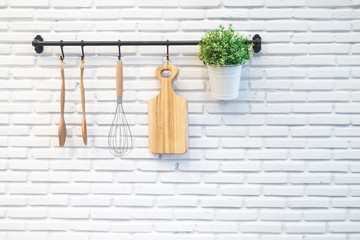 kitchen rack on white brick wall