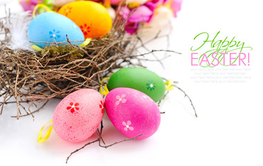 Colorful easter eggs in nest on a white background