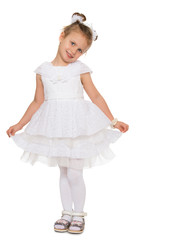 Fototapeta premium Cute little girl in fancy white dress gown holds his hands over the edge - Isolated on white background