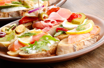 Open sandwiches with salmon, eggs, mussels, jamon and herring
