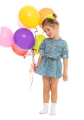 Fototapeta na wymiar Lovely little girl in a short blue summer dress, with a bouquet of balloons - Isolated on white background