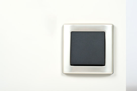 light switch with silver frame on the wall