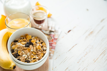 Breakfast - muesli and fruits on white background
