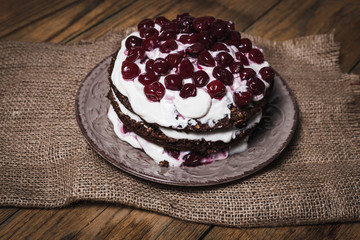 Brownie cake with ground cherry on a wooden board