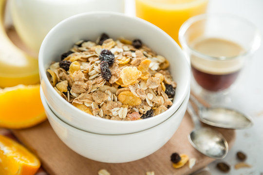 Breakfast - muesli and fruits on white background