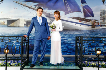 Stylish young bride and groom  near the boat