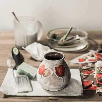 Decoupage accesories - brush, sponge, paint, tissues, pencils and papers on wooden table - square. 