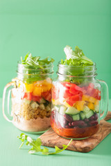 Fototapeta na wymiar vegan quinoa bean vegetable salad in mason jars