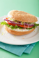 tomato sandwich on bagel with cream cheese onion lettuce alfalfa